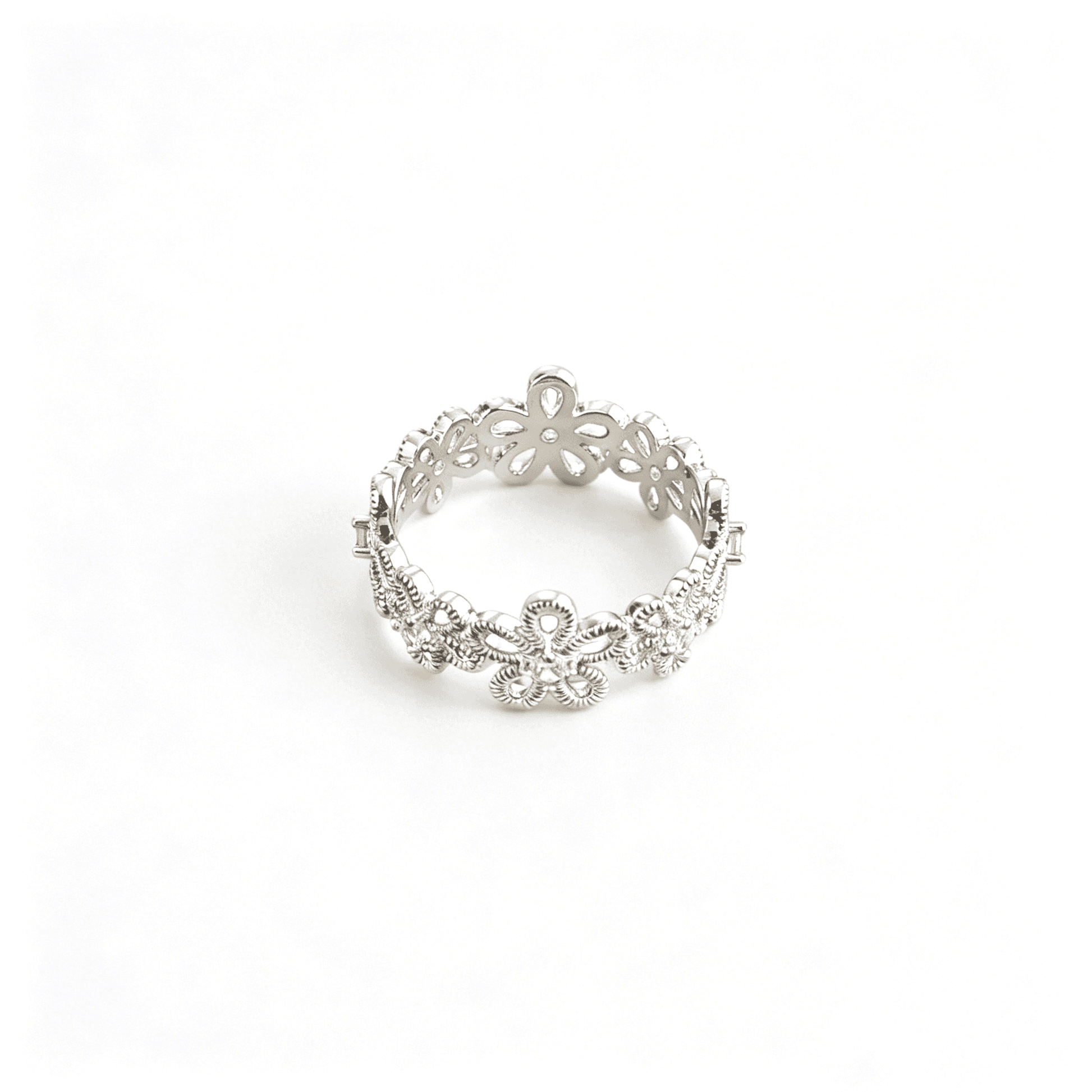 Front studio shot of the silver plated floral filigree eternity ring with shimmering cz stone centers.