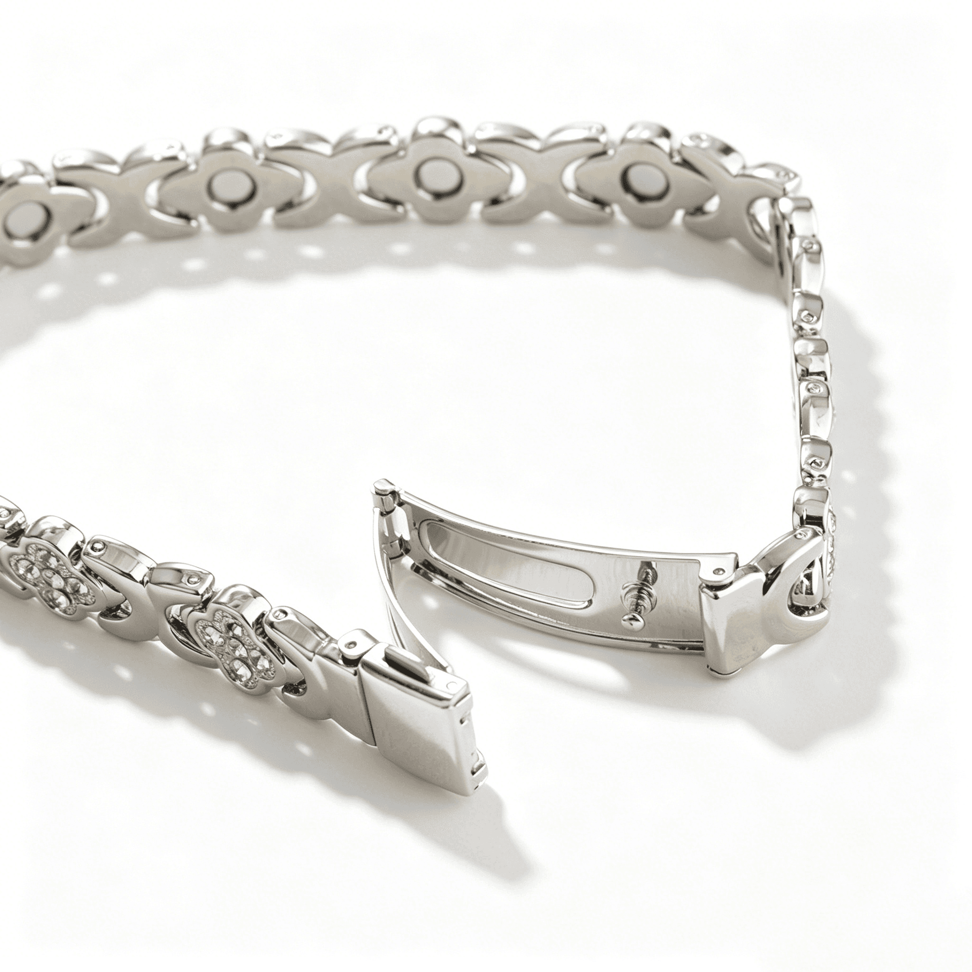 Side view of a silver four leaf clover bracelet highlighting the detailed interlocking heart design and polished finish.