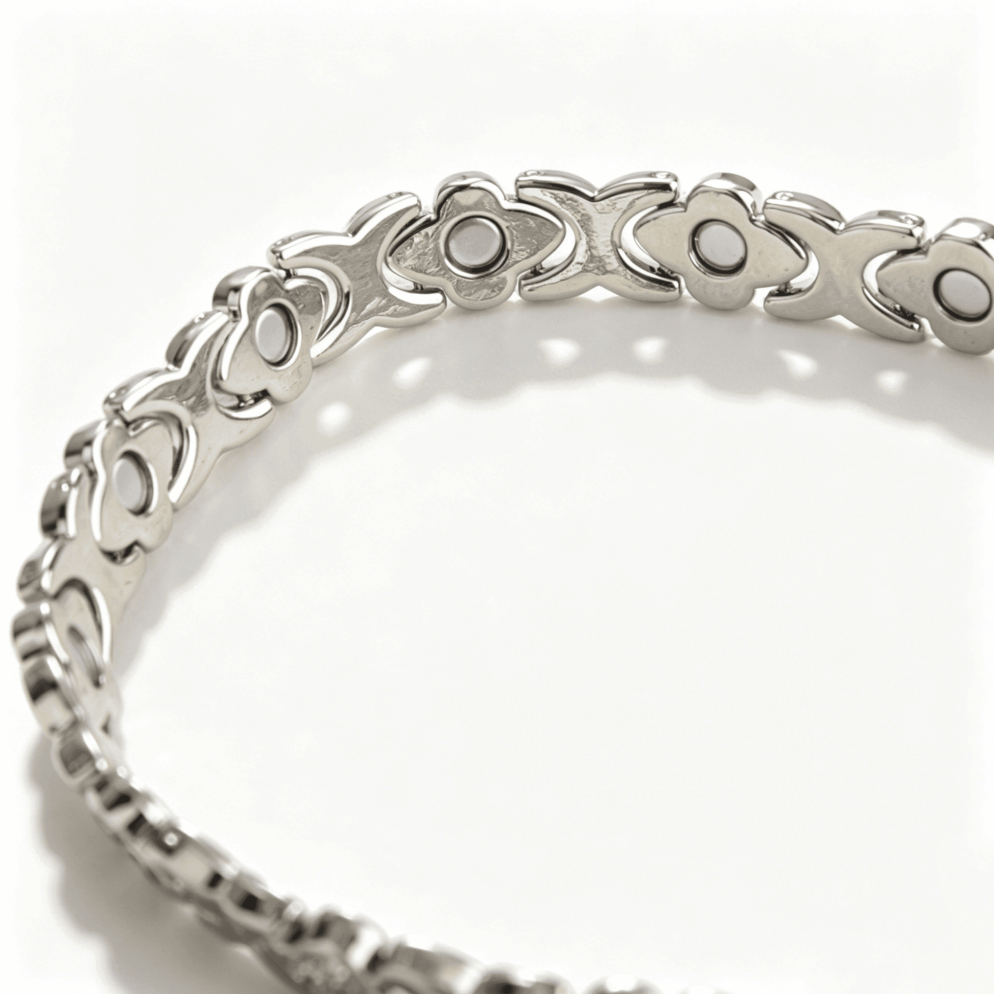 A sparkling silver four leaf clover bracelet designed with four polished hearts for an elegant lucky charm look.