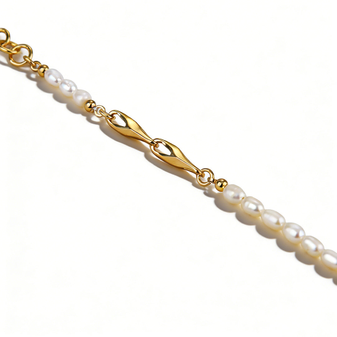 Macro shot of a genuine white natural pearl, highlighting its organic texture and brilliant iridescent glow.