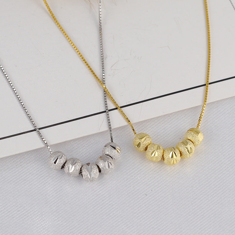 Gold-tone and silver-tone geometric bead necklaces displayed side by side to compare the two color options.