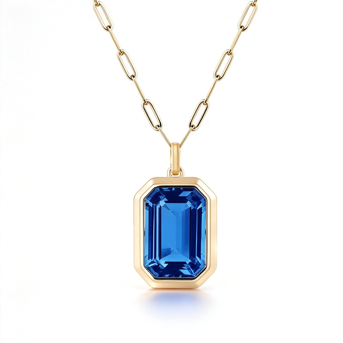 Geometric cut pendant necklace with a blue rectangular centerpiece and linked chain.
