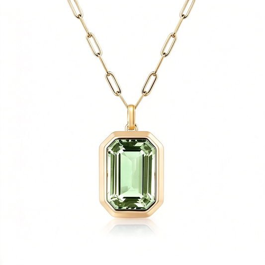 Green rectangular pendant necklace shown with its linked chain on white.