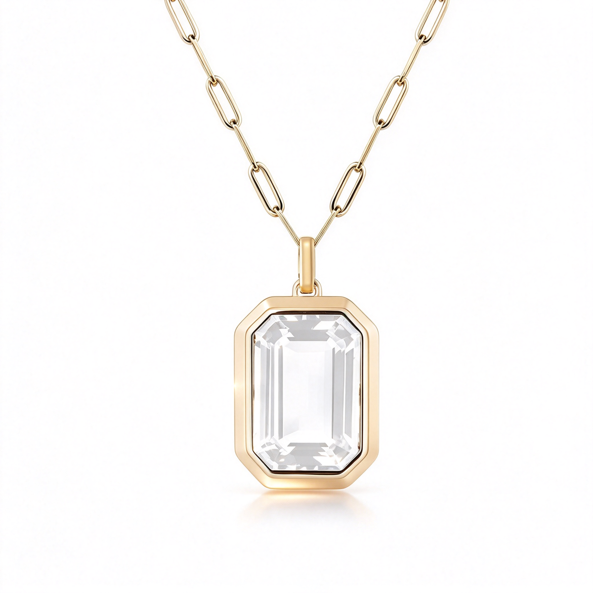 Clear rectangular pendant necklace with a gold-tone frame on a white background.
