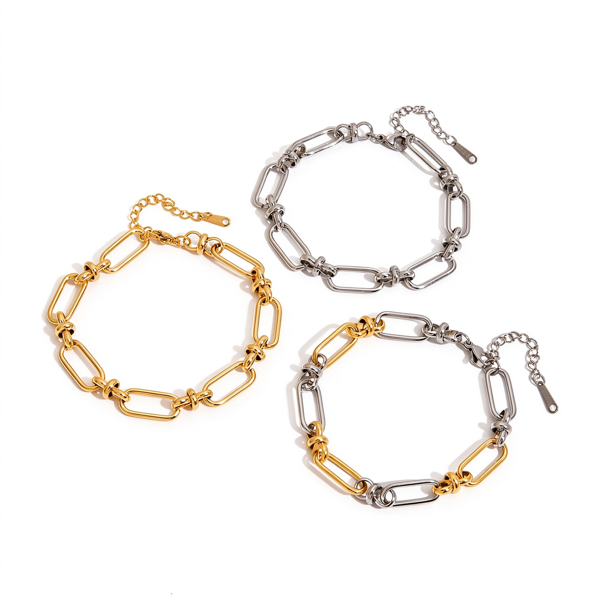Geometric link chain bracelets in gold tone, silver tone, and two-tone finishes displayed together on white