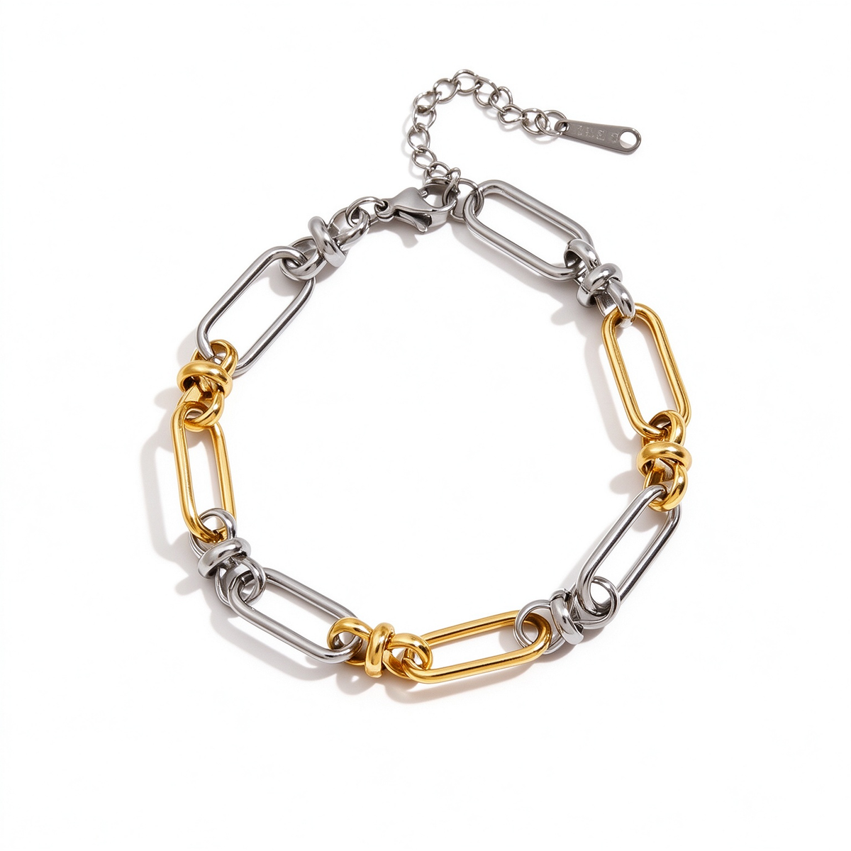 Two-tone gold and silver geometric link bracelet shown from above with elongated chain links