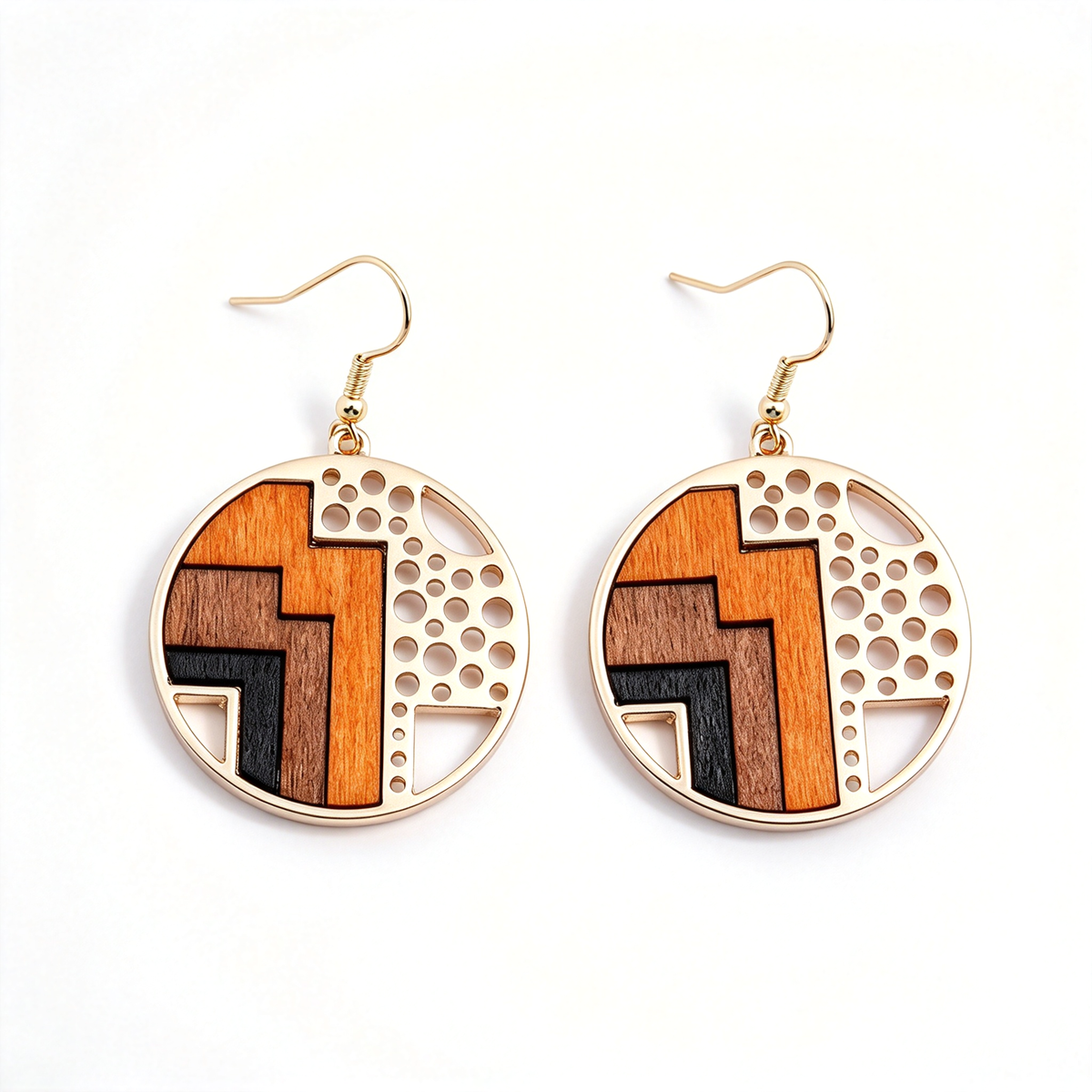 Rounded geometric earrings with orange and brown panels and decorative patterned details.
