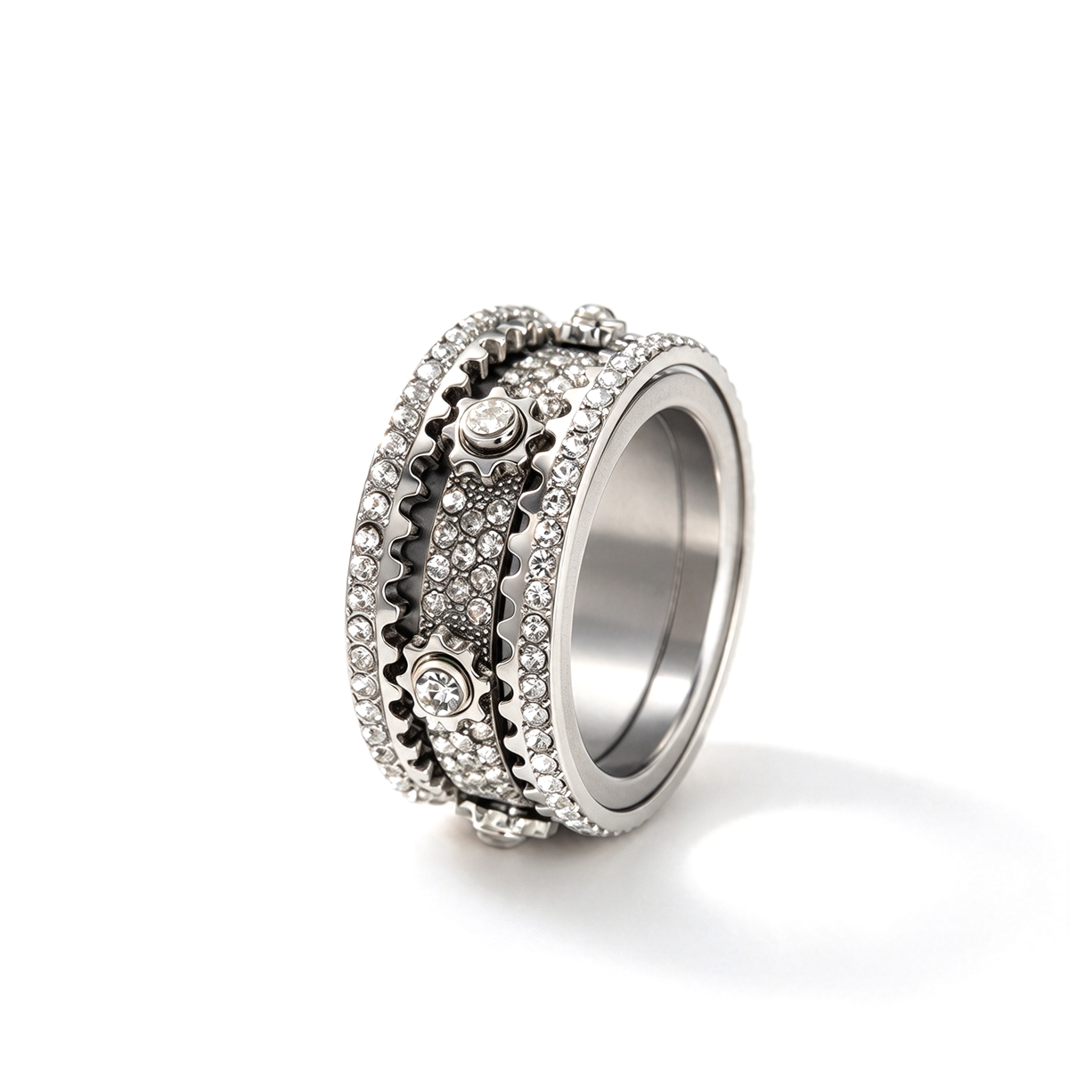 Silver-tone ring shown alone from an angled view with layered bands and small decorative accents.