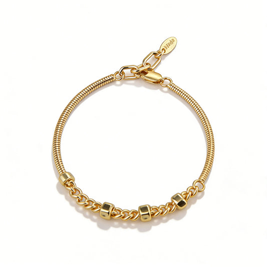 A modern gold chain bracelet for women featuring a sleek snake chain and industrial hex nut links.