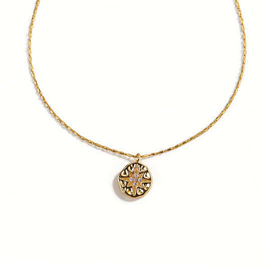 18k gold plated necklace with a detailed eight-point star coin medallion.