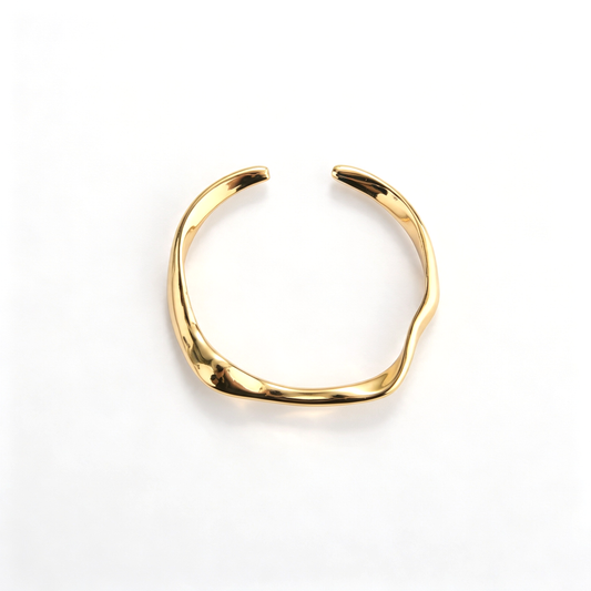 Gold cuff bracelet with a sculptural open silhouette and curved design