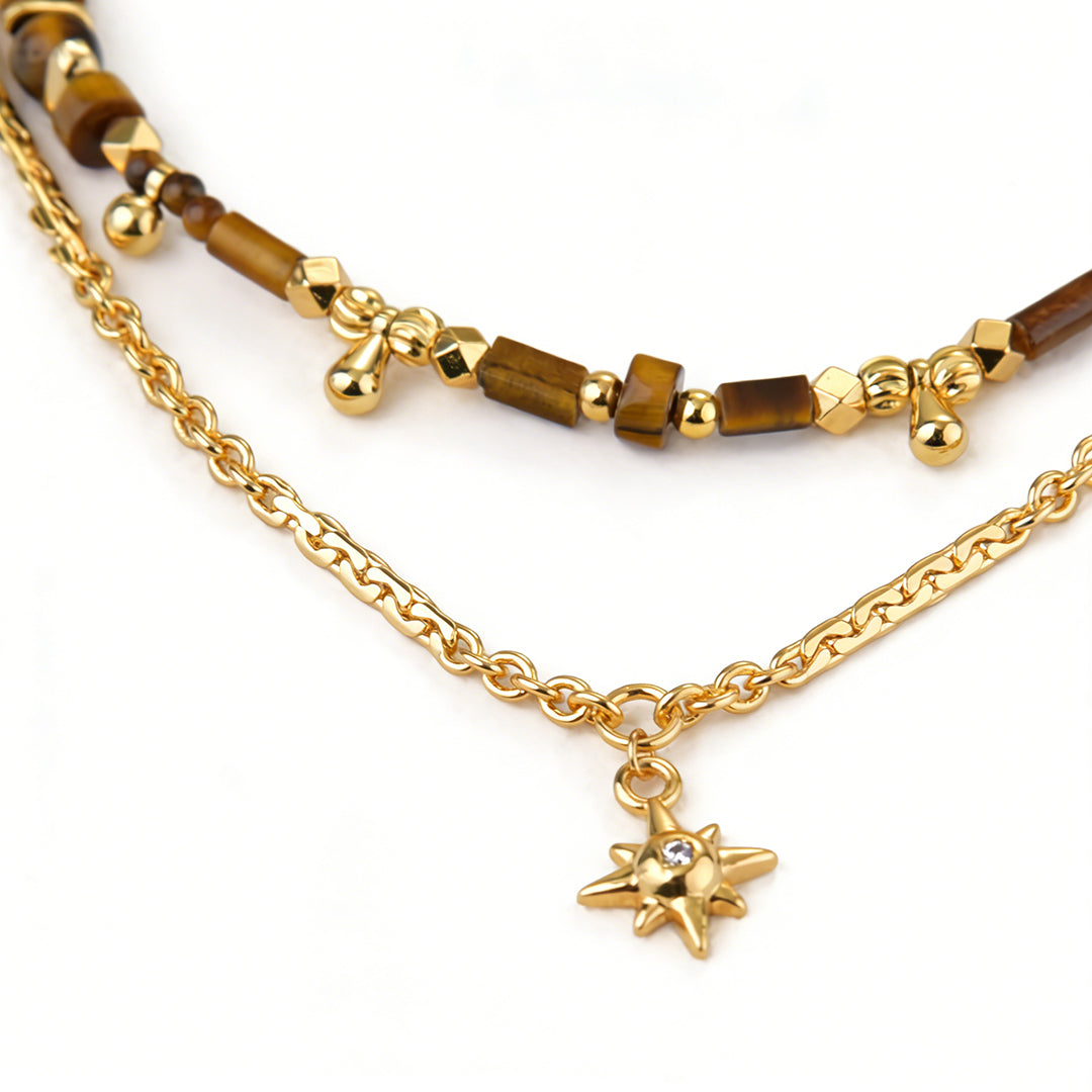 Radiant gold pendant necklace with a cubic zirconia halo surrounding a tiger eye stone.
