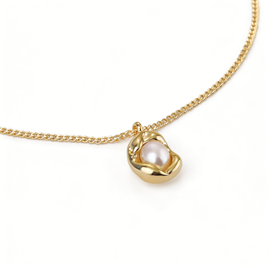 Organic style gold pendant necklace with a smooth curved pea pod silhouette.