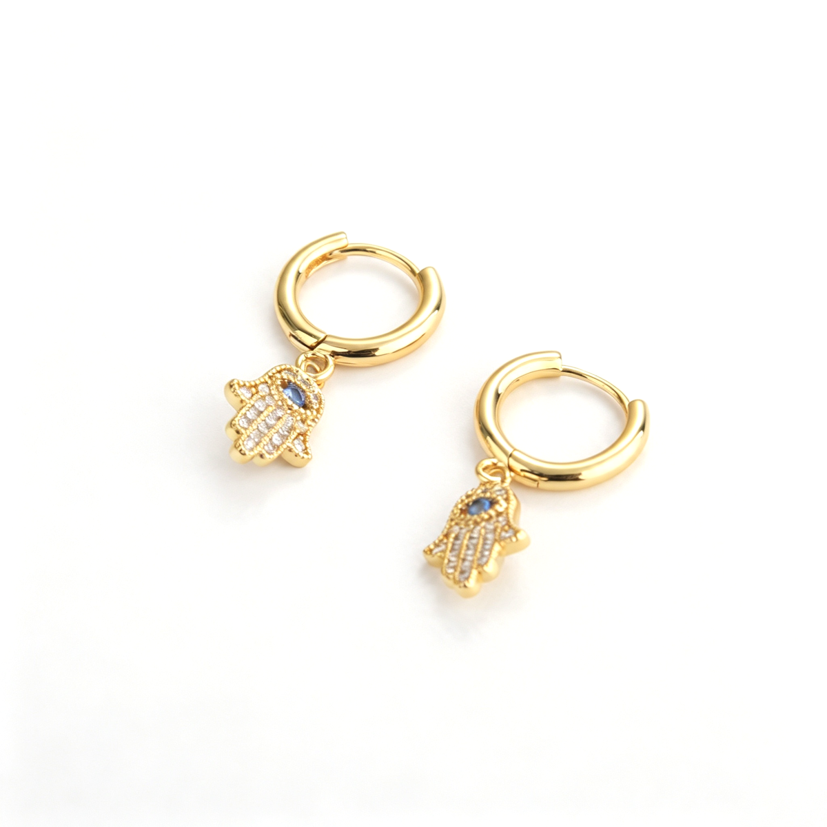 Close-up of the hamsa hand charms showing the blue center accents and dotted details