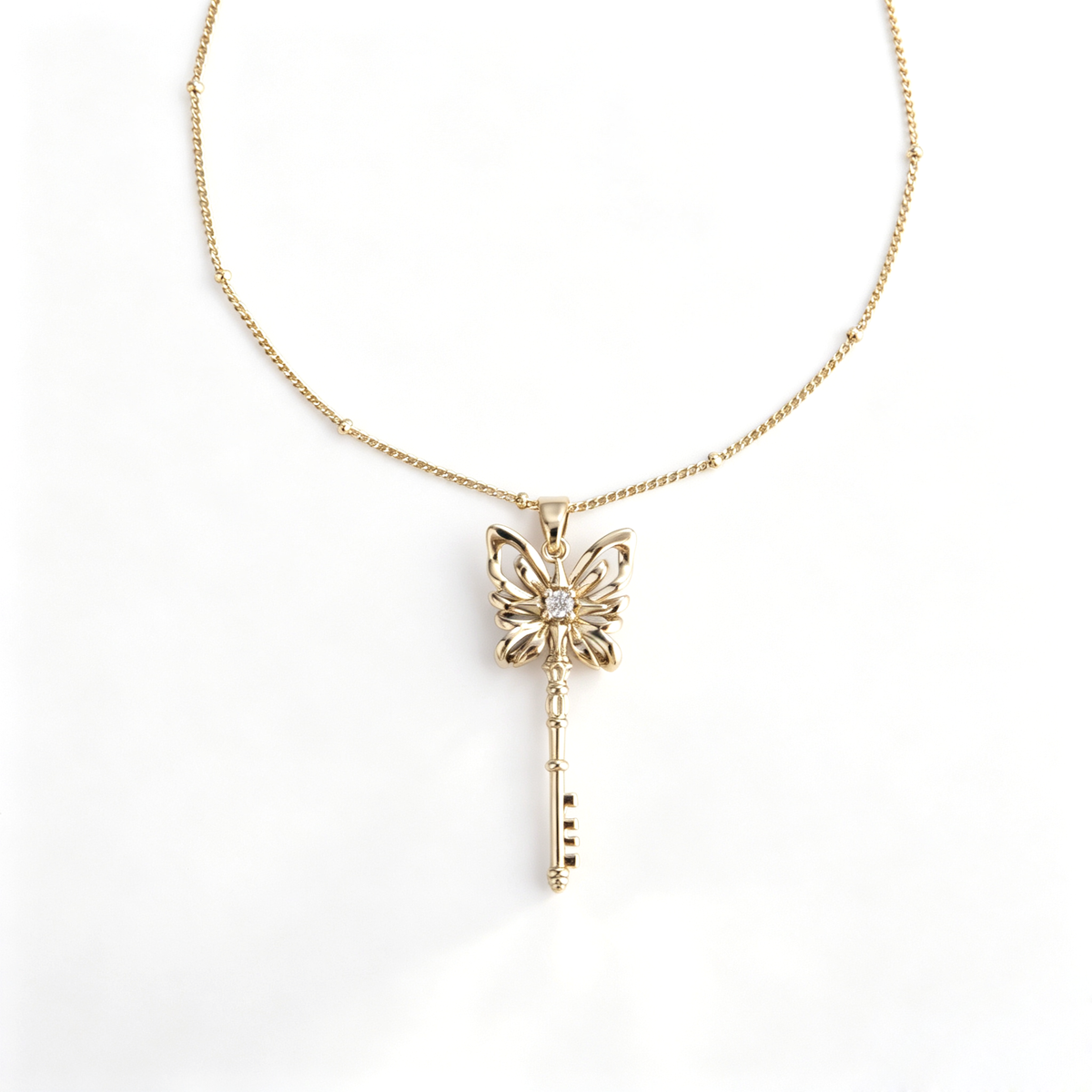 Handcrafted gold butterfly key pendant long necklace with beaded satellite chain
