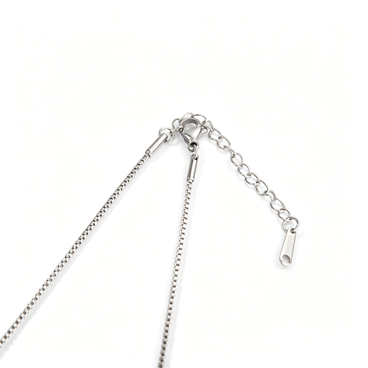 Full view of handcrafted silver double charm cross necklace on titanium steel box chain
