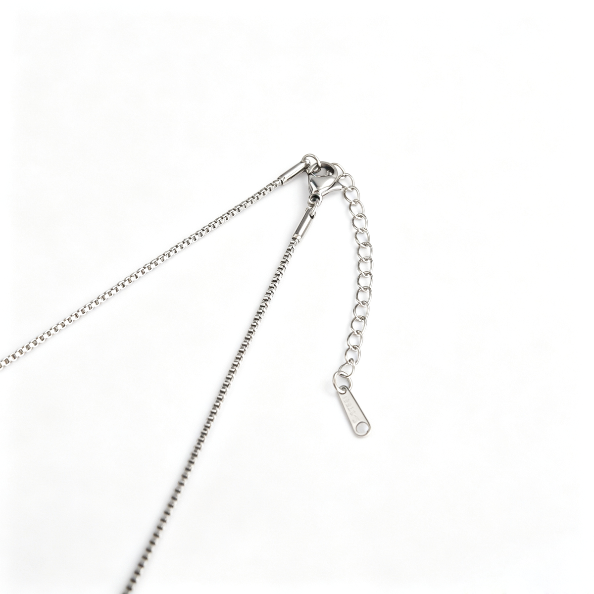 Full view of handcrafted silver nail cross pendant on titanium steel box chain