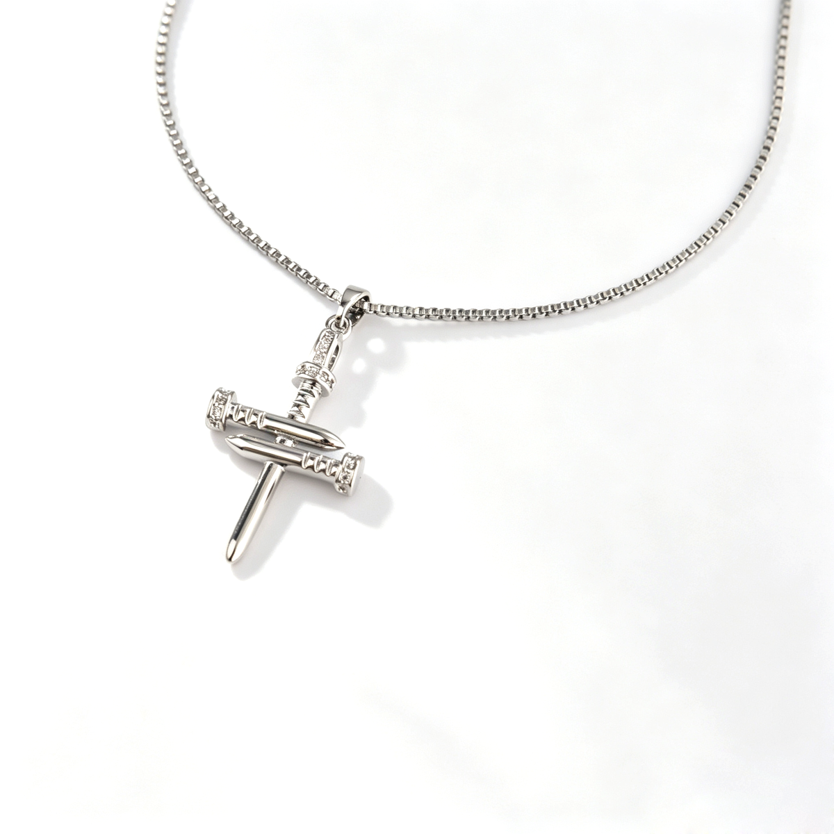 Front view of 1.2x2cm handcrafted silver copper nail cross pendant with pavé crystals
