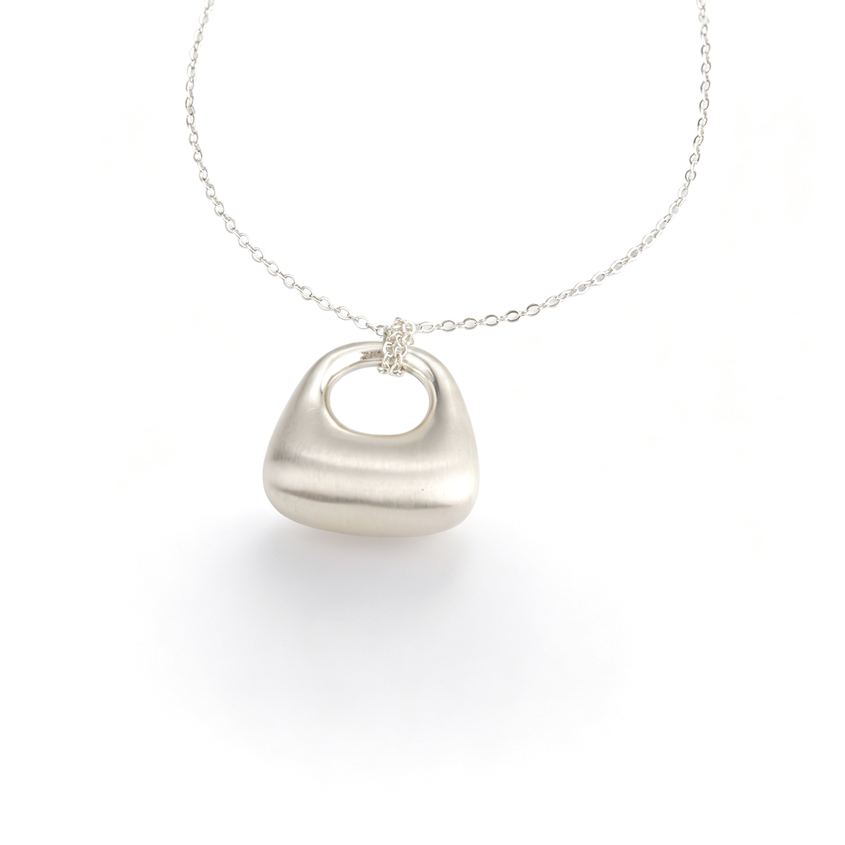 Handcrafted silver sculptural pendant long necklace full view on link chain