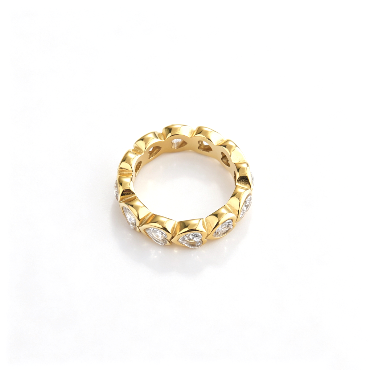 Heart band ring shown from a low front angle with repeated heart-shaped details