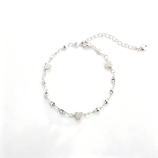 Back view of the heart charm bracelet showing the chain, clasp, and extension