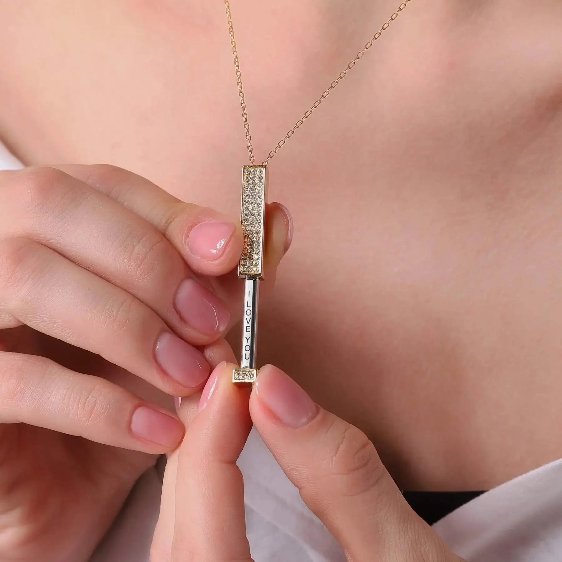 Gold-tone hidden I Love You necklace opened to reveal the vertical engraved message