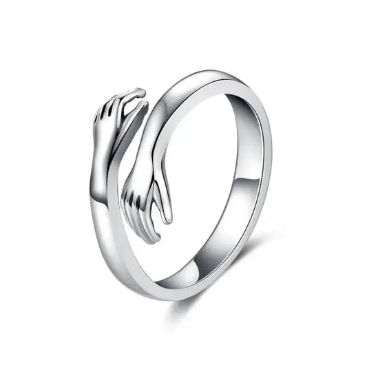 Silver-tone stainless steel adjustable ring with two sculpted hands on white