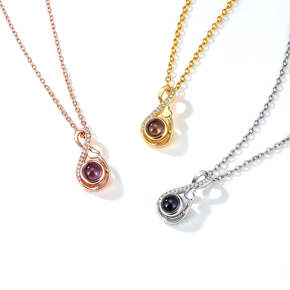 Infinity heart necklace shown in three color options with matching chains and rounded projection pendants.