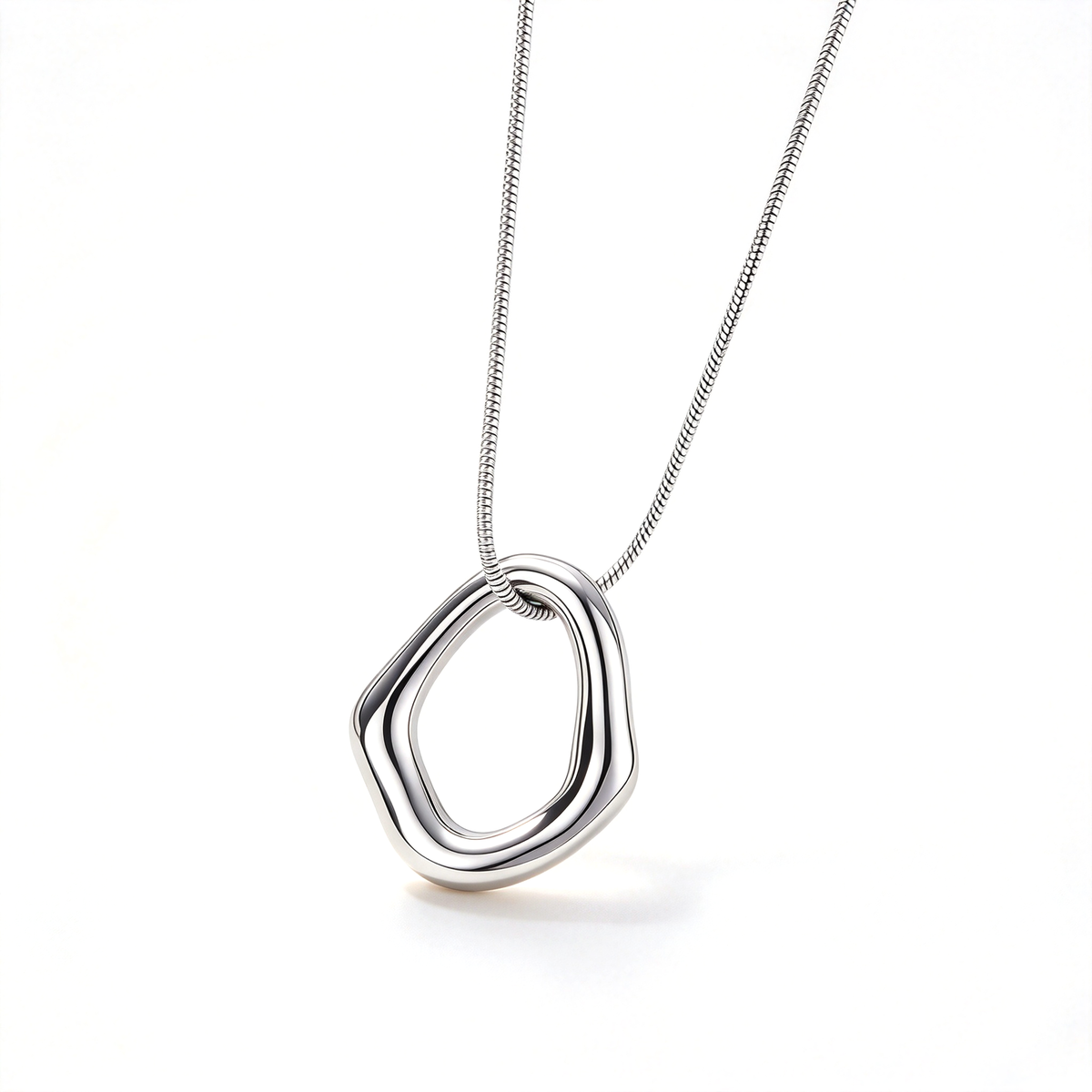 Silver-tone irregular geometric pendant necklace shown against a clean white background.