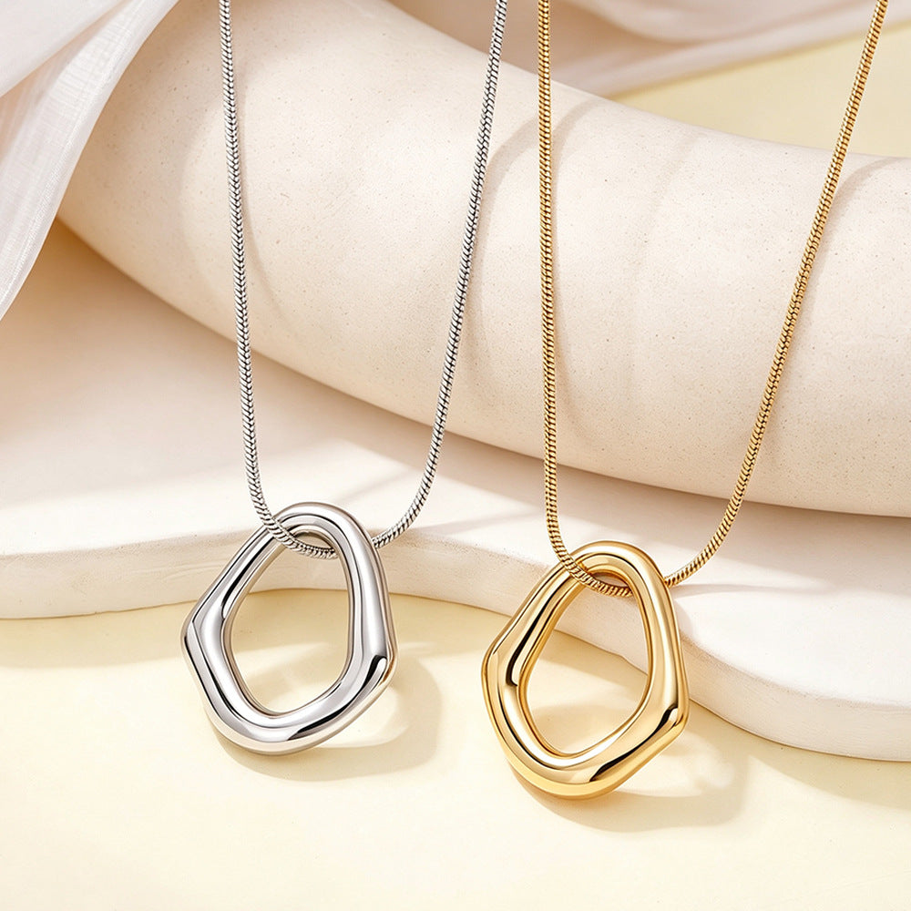 Gold-tone and silver-tone geometric pendant necklaces displayed together on a neutral backdrop.