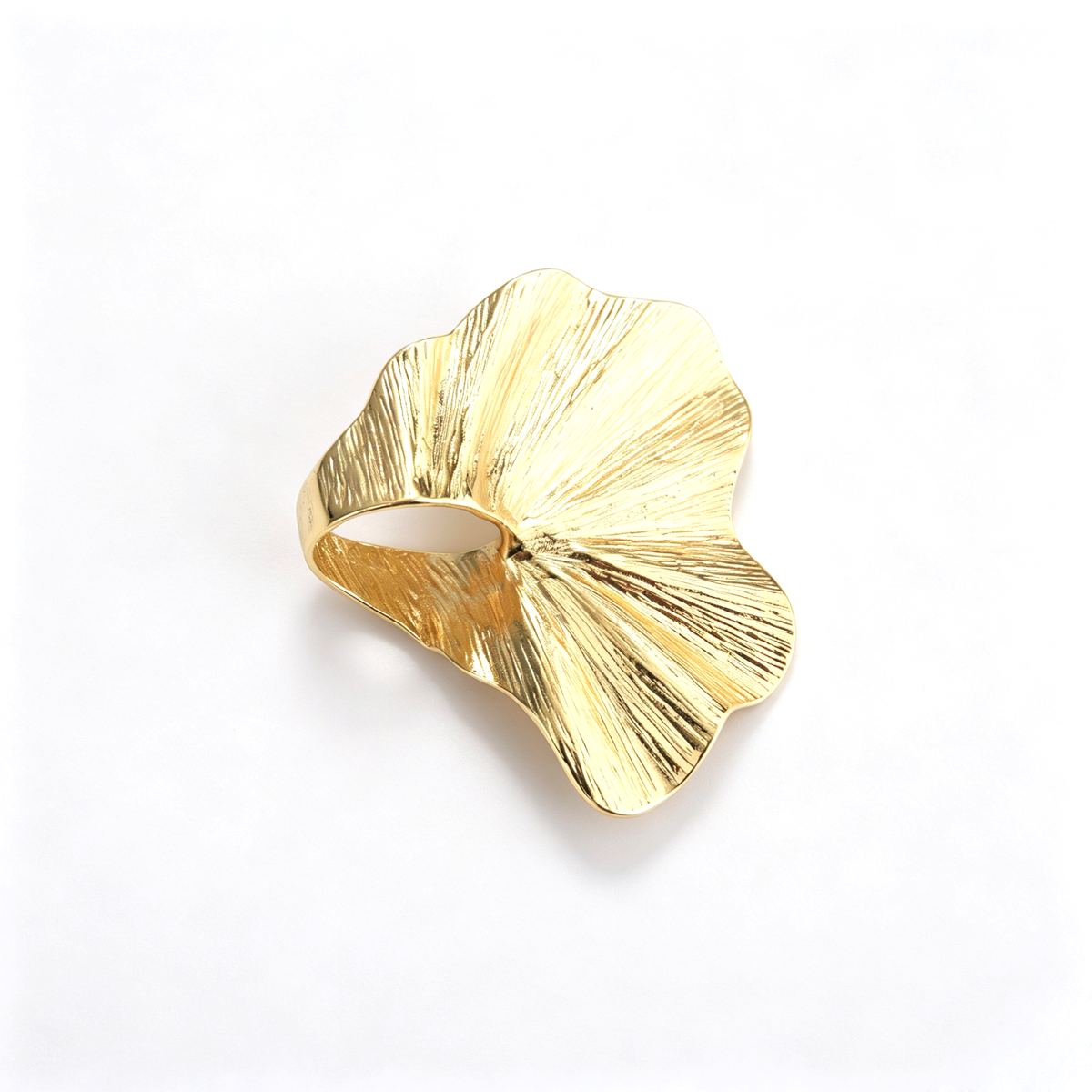 Top-down view of an 18k gold-plated irregular ginkgo leaf statement ring showing pleated texture.