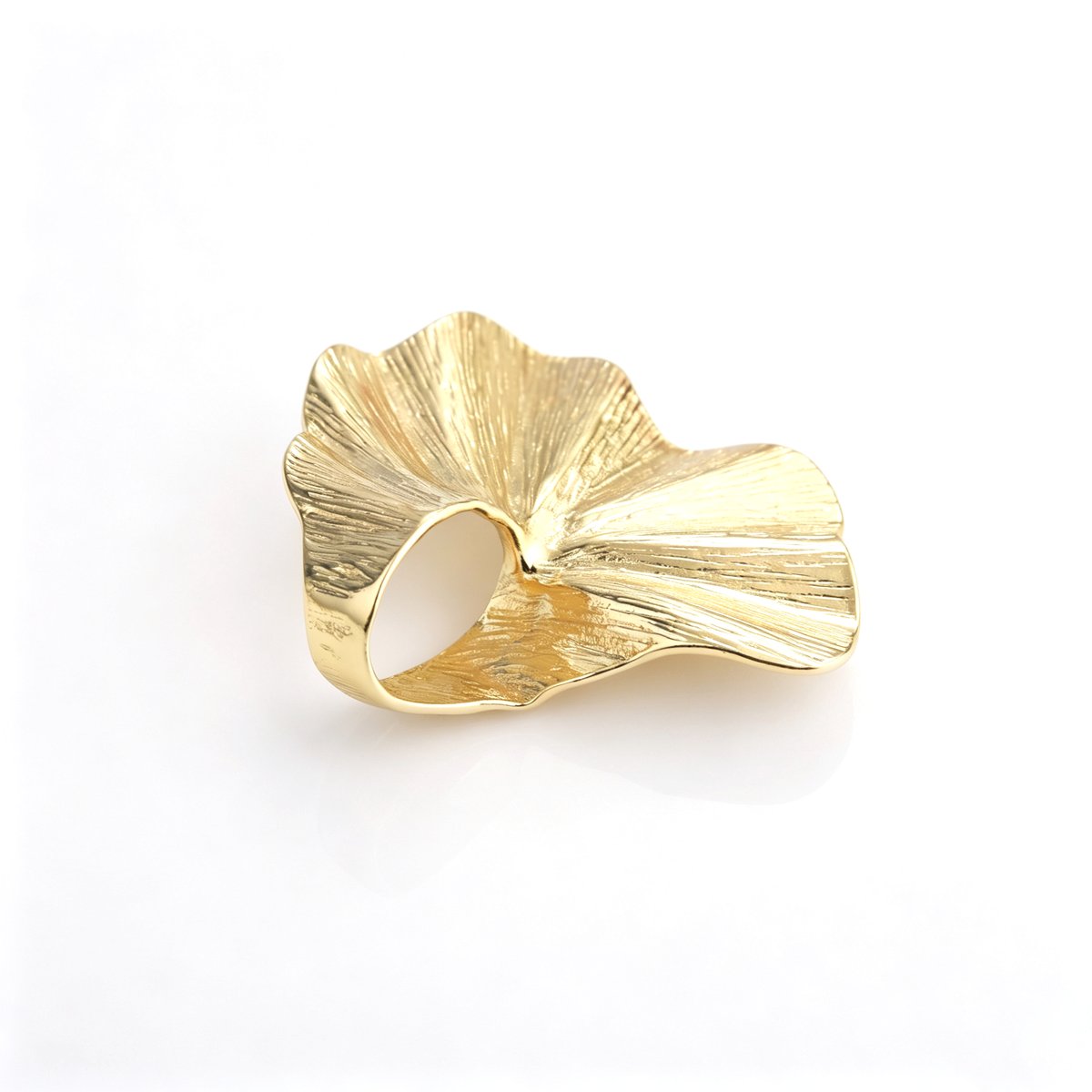 Angled side view of the gold 3D ginkgo leaf cocktail ring highlighting band curvature and texture.