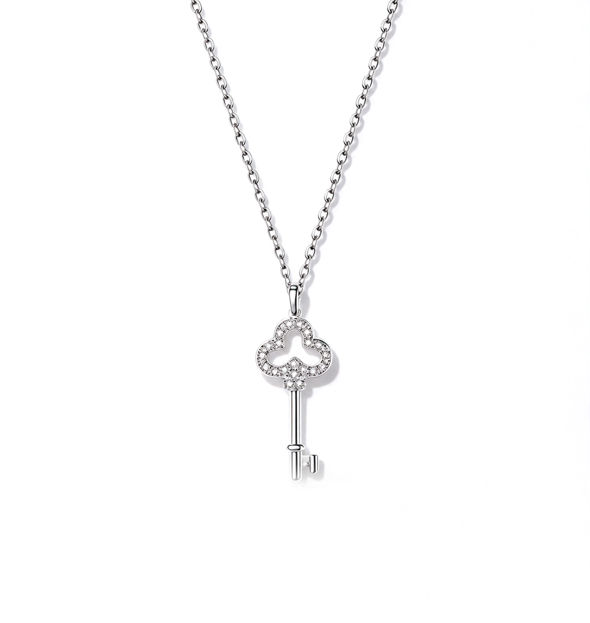 Key pendant necklace with an ornate openwork bow and slim key design on a delicate chain