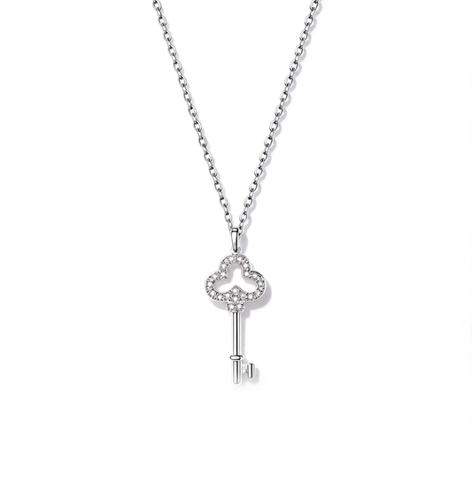 Key pendant necklace with an ornate openwork bow and slim key design on a delicate chain