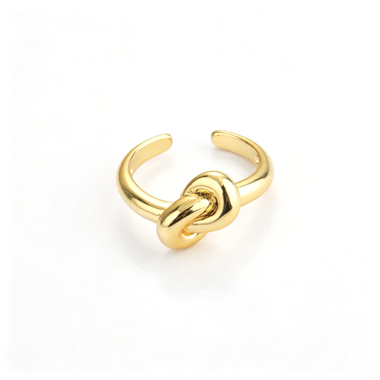 Knot open cuff ring shown from a front view with a sculptural center detail