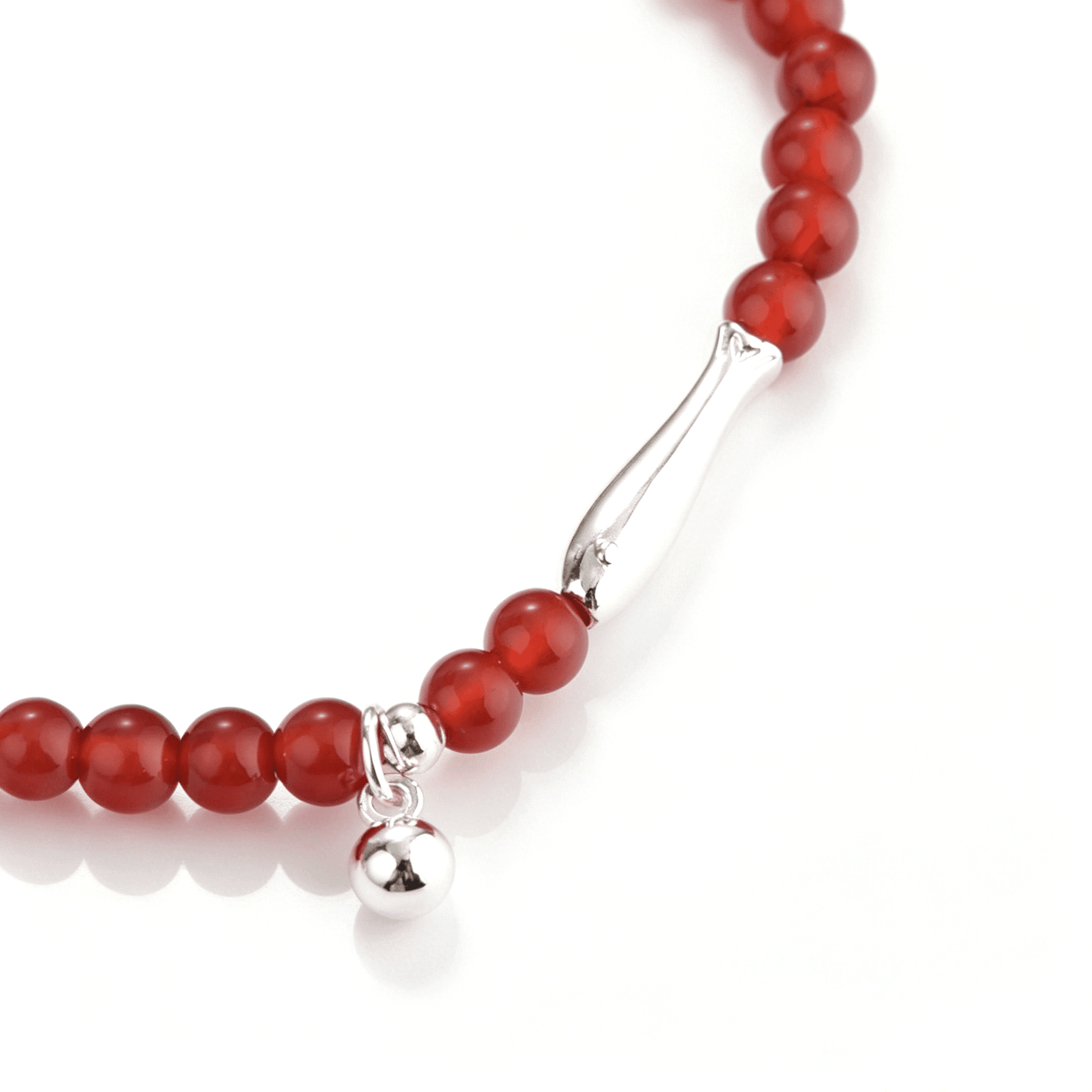 Close-up of the koi-shaped silver-tone accent, red agate beads, and single round dangle charm.