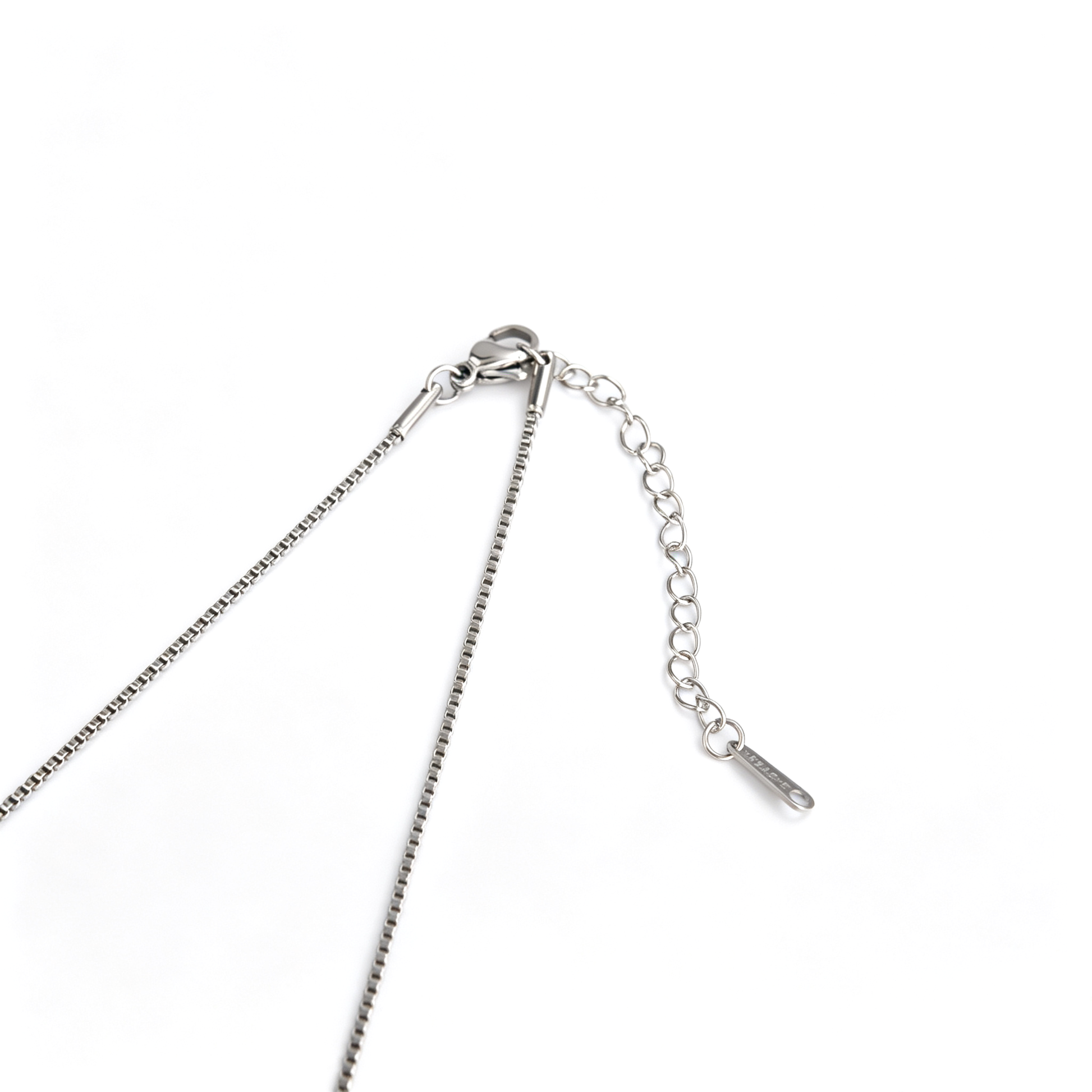 Lobster clasp and extender chain on the silver-tone cross necklace.