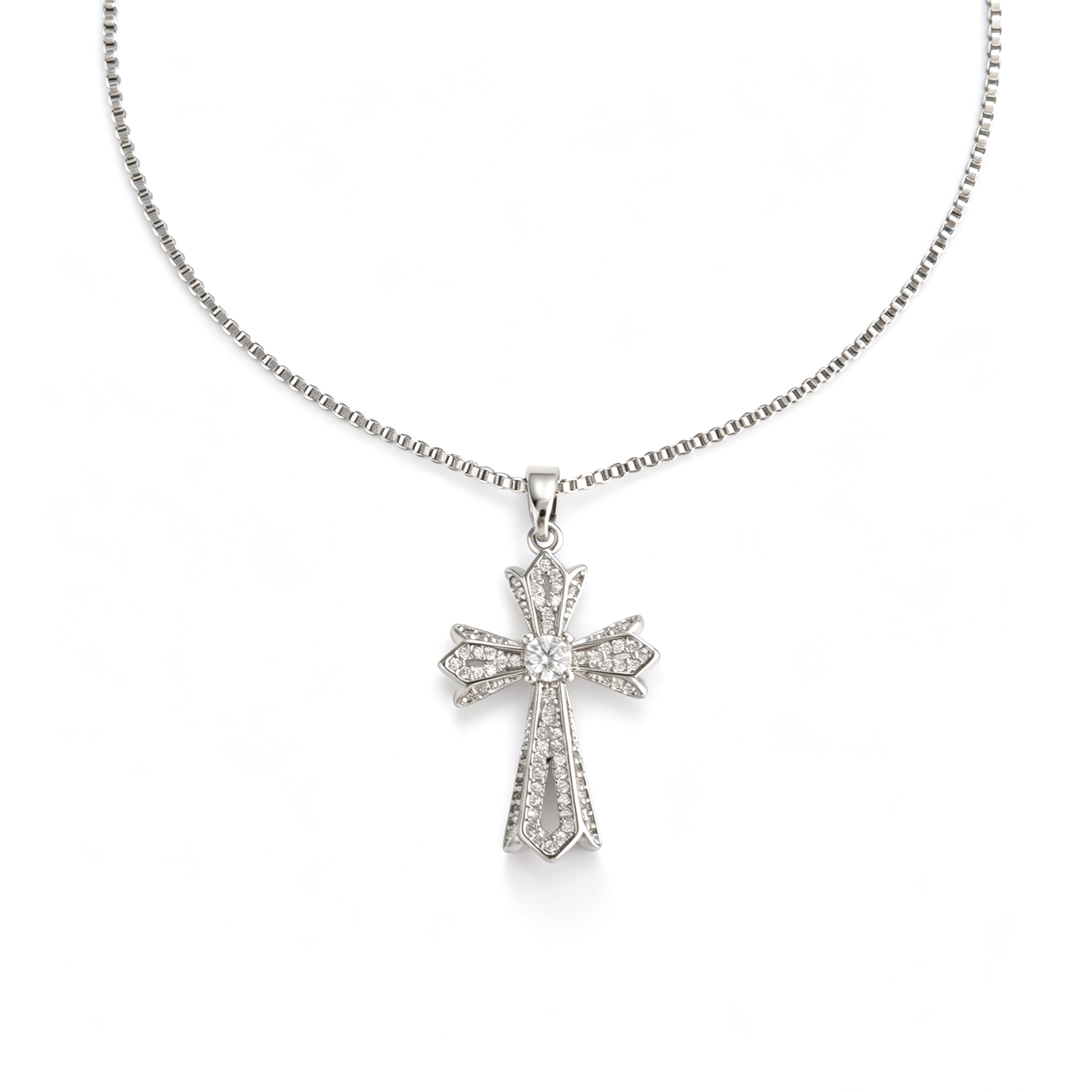 Front view of the layered silver-tone cross pendant with clear faceted accents.