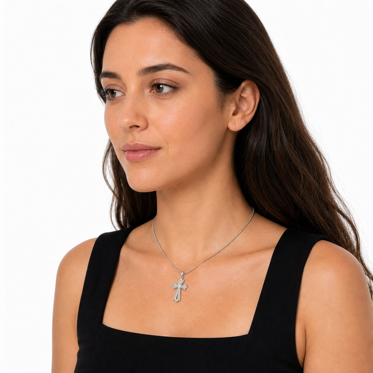Opposing three-quarter portrait of a young woman wearing the short silver-tone cross pendant necklace near the collarbone.