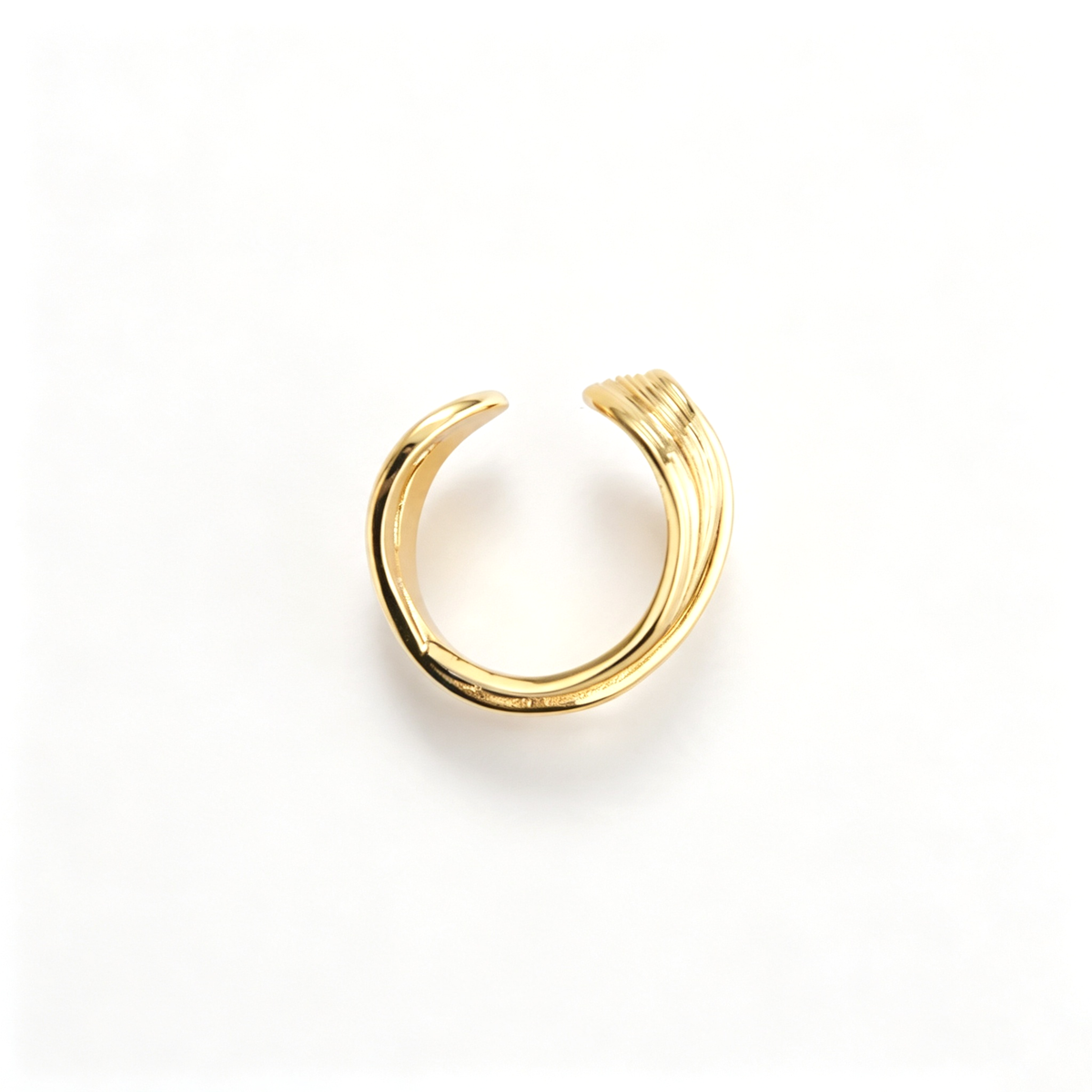 Layered wave cuff ring shown from an angled view, highlighting the overlapping bands