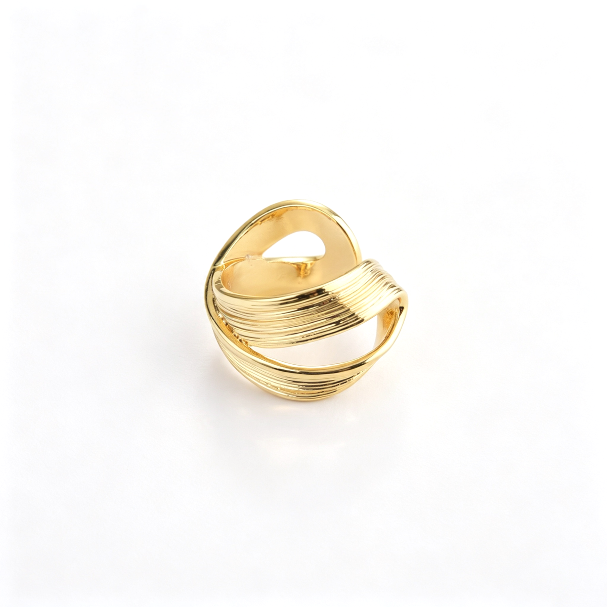 Layered wave cuff ring shown from a three-quarter view with overlapping curved bands