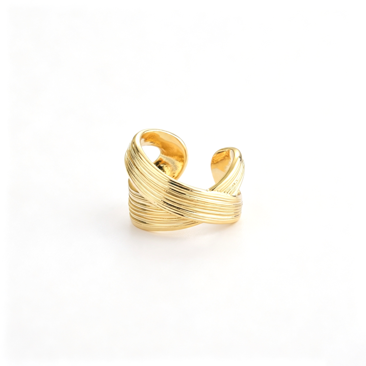Open cuff ring shown from an angled profile, highlighting the raised ribbed bands