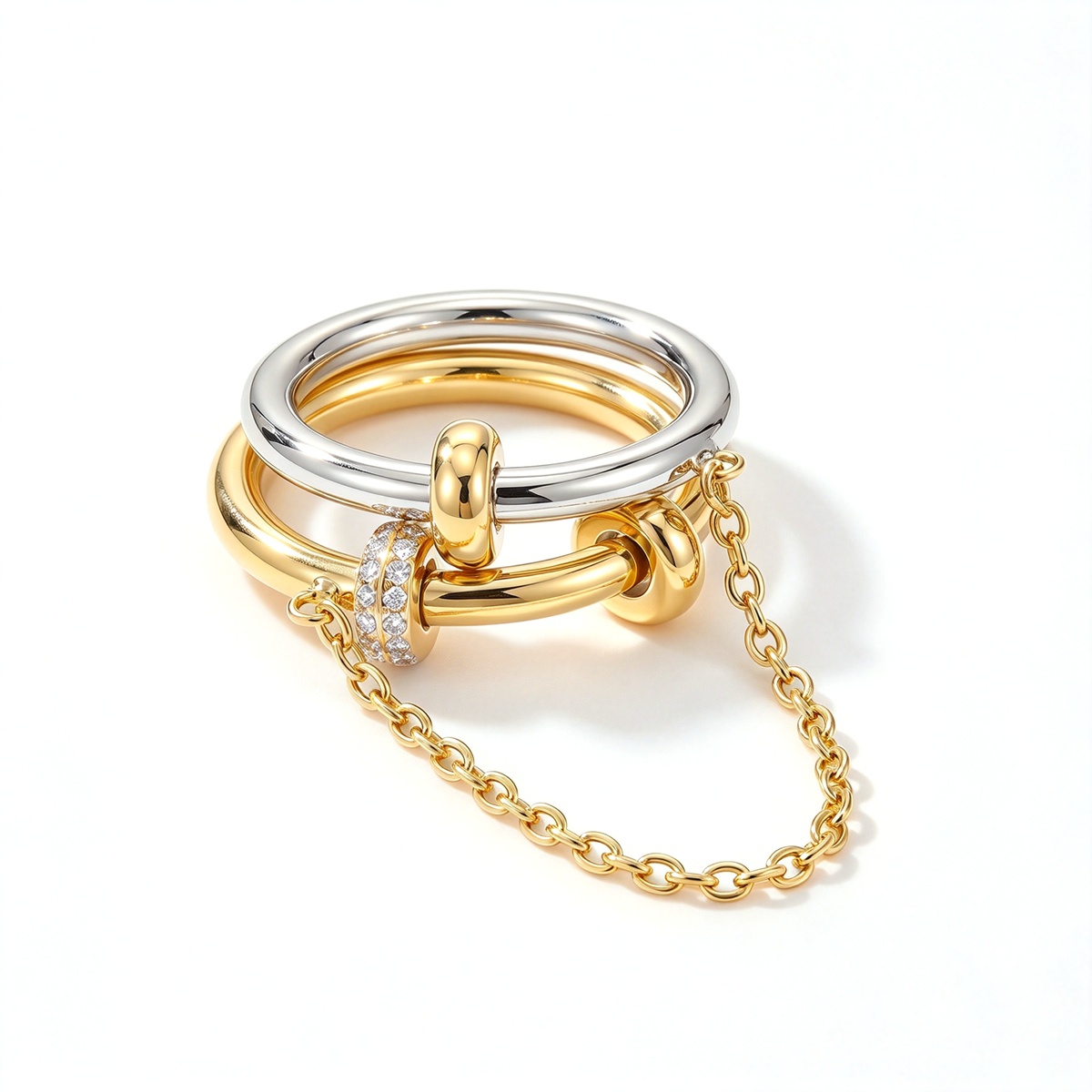 Angled view of a two-tone linked ring set with a draped chain and pink decorative accents