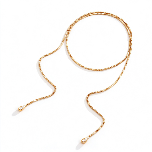 Gold-tone long necklace arranged in a loose loop to show its extended chain and two rounded ends