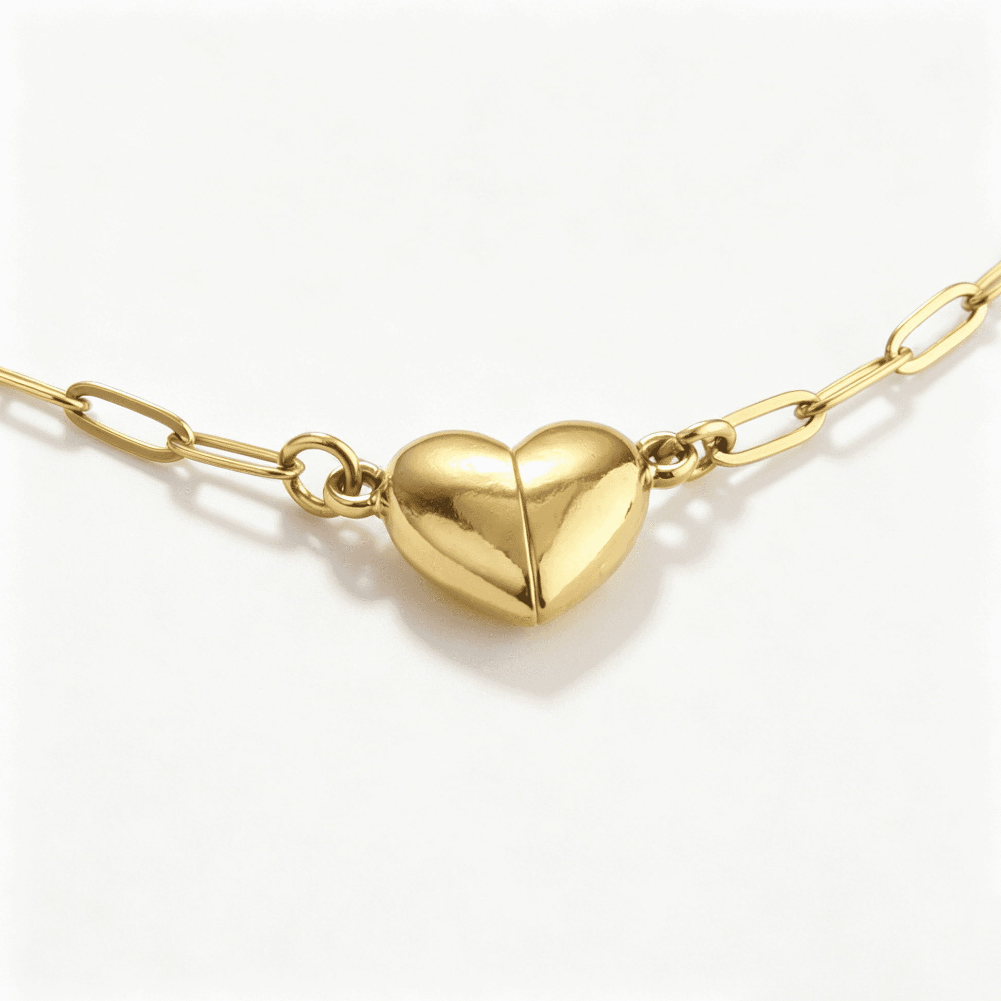Frontal close-up of the fully connected magnetic gold heart, formed by matching necklaces for couples.