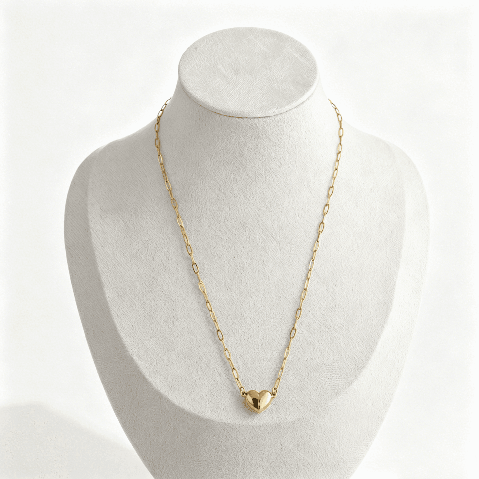 The matching necklace for couples displayed on a white jewelry mannequin, showcasing how it hangs with the magnetic heart connected.