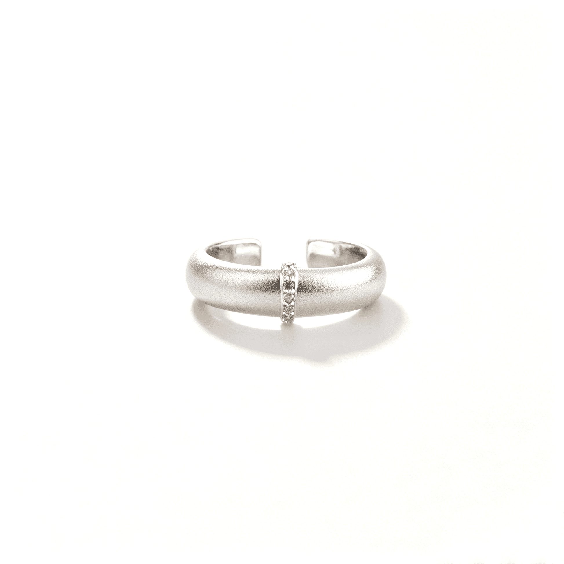 Front view of the silver-tone matte statement ring with a slim vertical row of zircon accents.