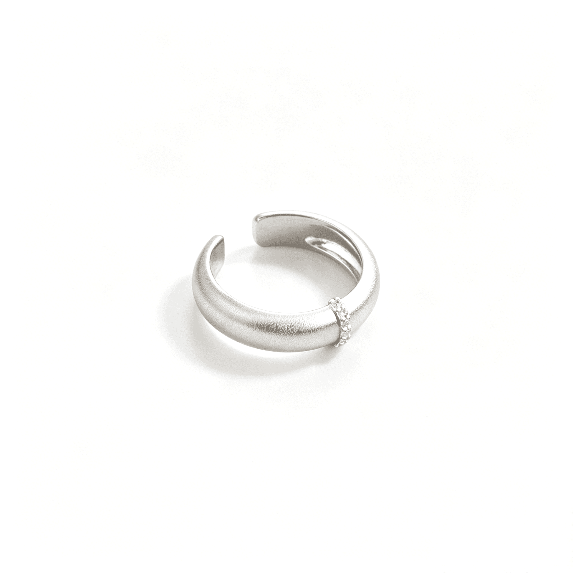 Three-quarter view of the silver-tone adjustable ring showing its wide sculpted band and open back.