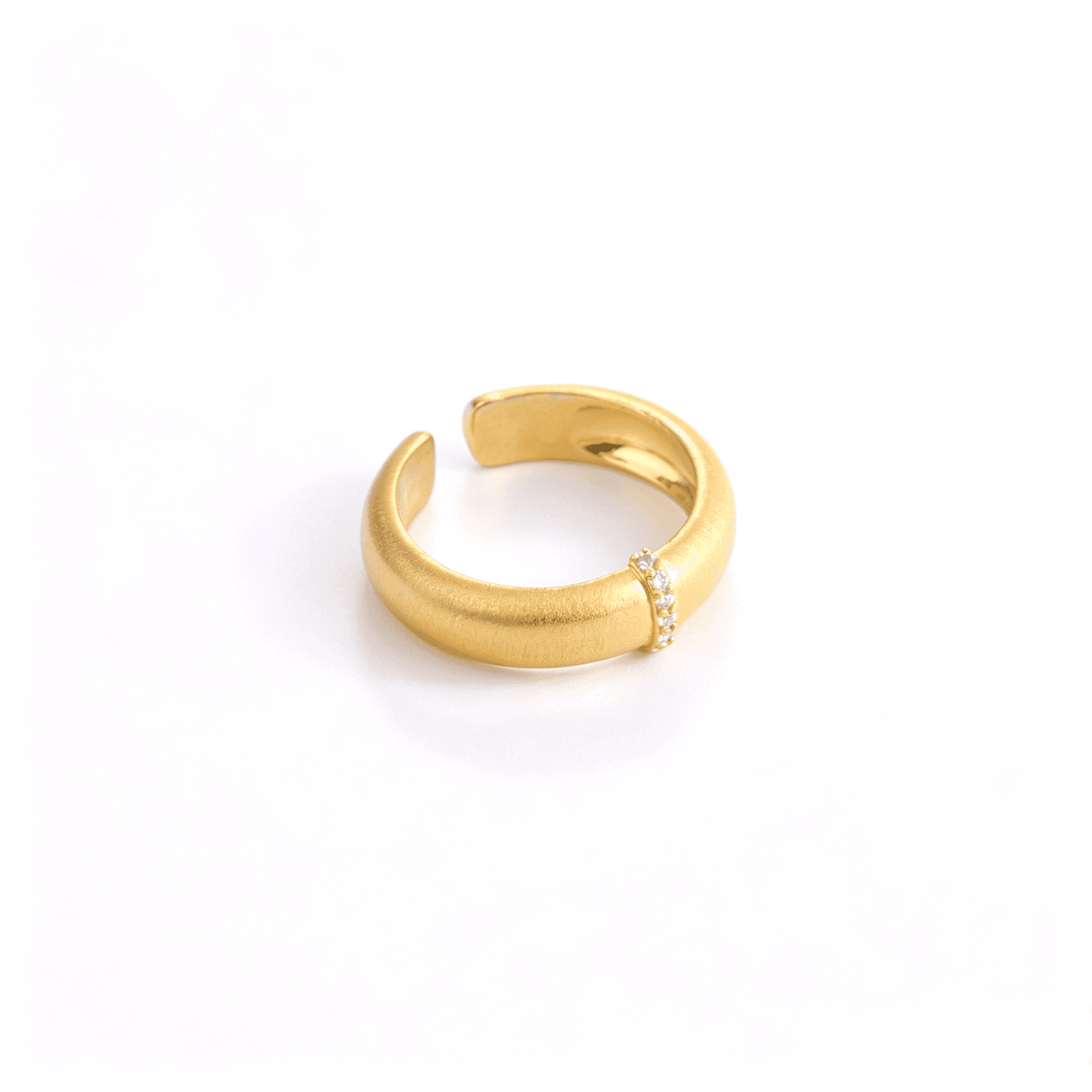 Three-quarter view of the gold-tone adjustable statement ring showing the open band and brushed texture.