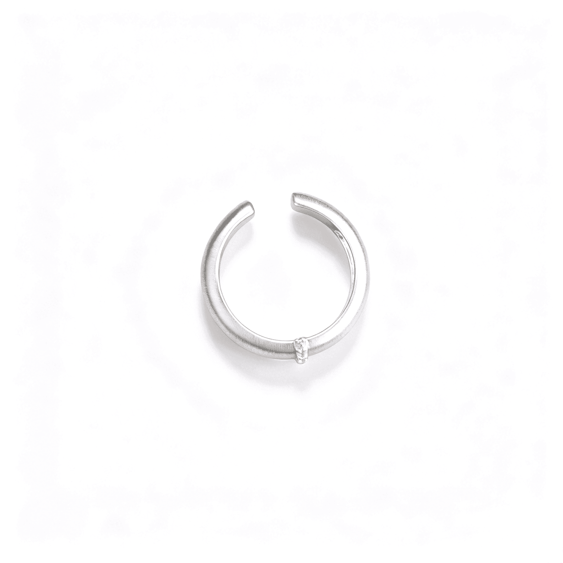 Top view of the silver-tone open ring showing the tapered band, gap, and single zircon detail.